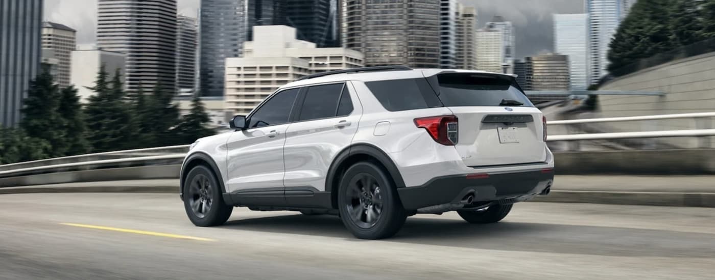 A white 2021 Ford Explorer from the rear at an angle.
