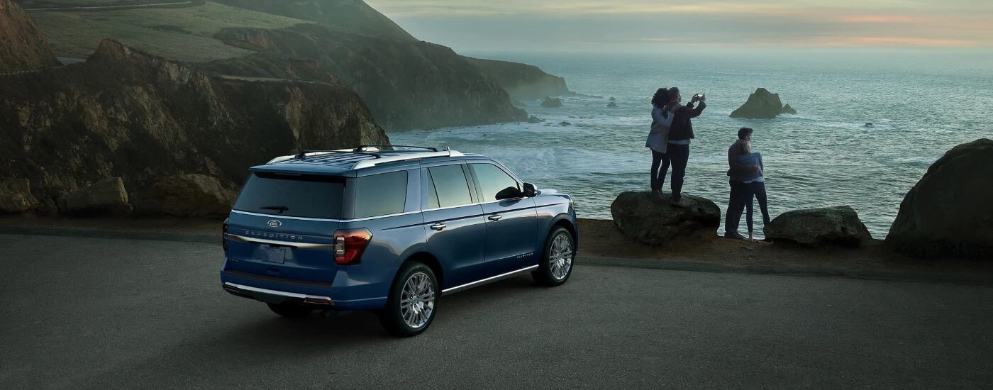 Blue 2023 Ford Expedition parked near a coastline.