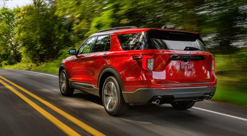 A red 2022 Ford Explorer ST-Line is shown from the rear at an angle.