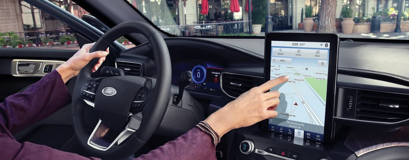 The black interior of a 2024 Ford Explorer is shwon from the passenger seat.