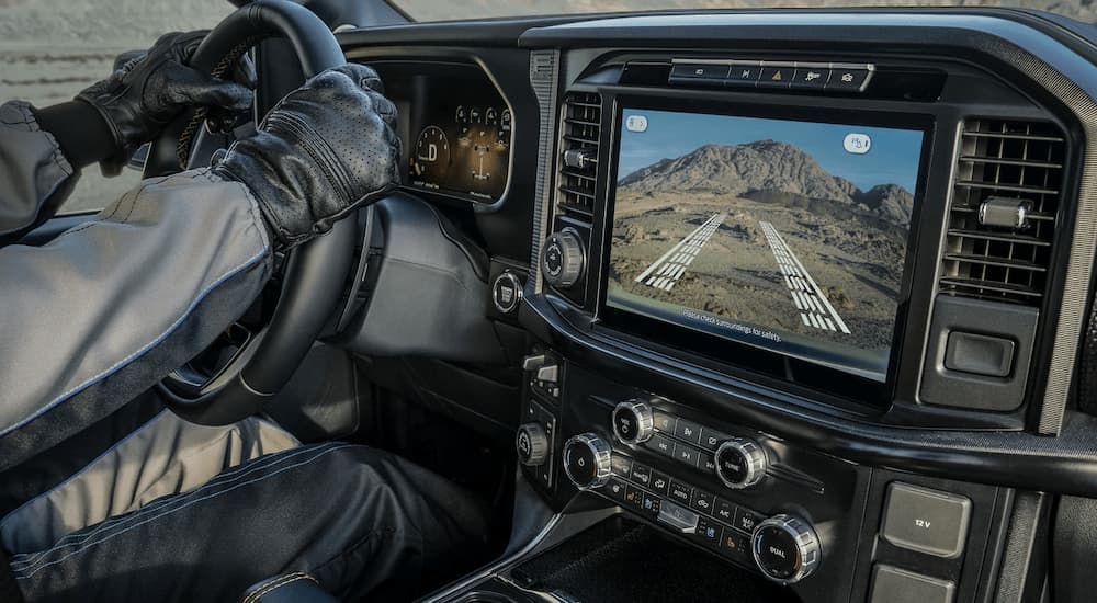 Driver off-roading in a 2025 Ford F-150 for sale near Jackson.