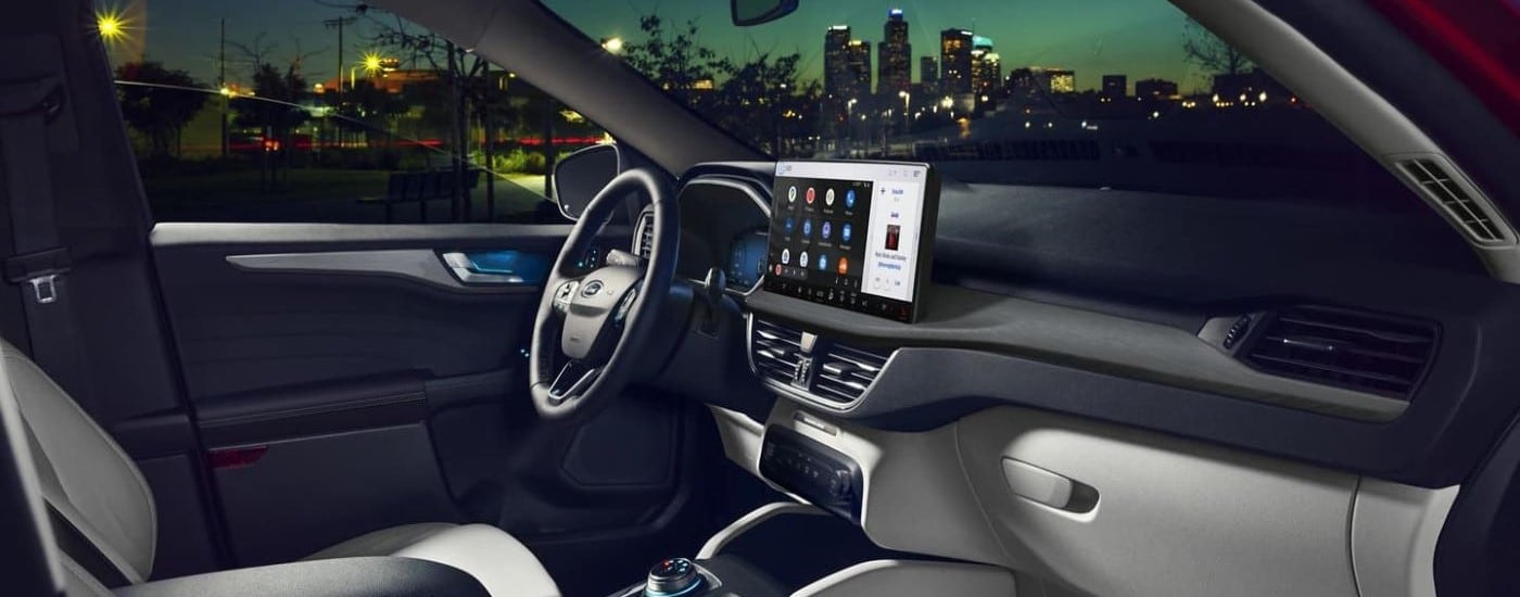 The black interior view of a 2024 Ford Escape, including the steering wheel and dashboard.
