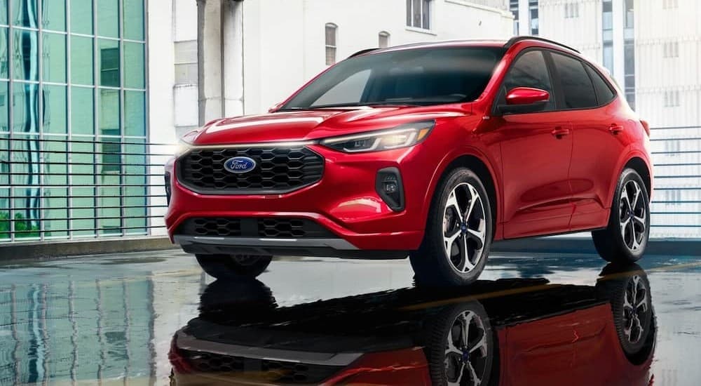 A red 2024 Ford Escape ST-Line Elite is shown parked on a parking spot.