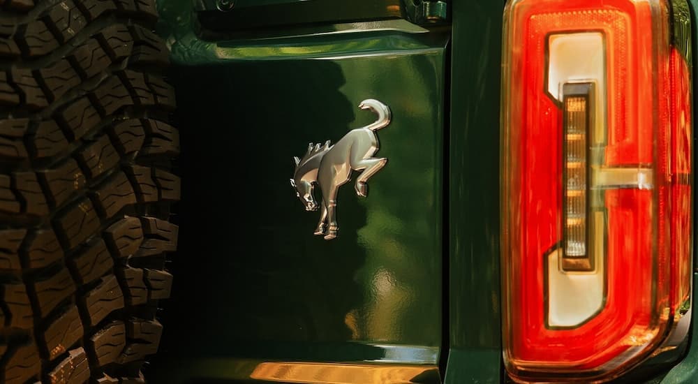 Bronco badge on the back of a green 2025 Ford Bronco for sale in Milan.