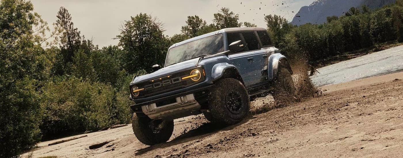 A blue 2024 Ford Bronco Badlands off-roading.