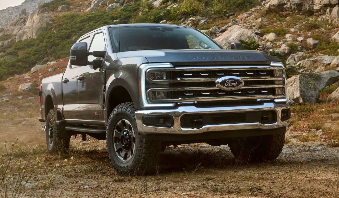 Two people exiting a 2025 Ford F-150® XLT pickup in Rapid Red hitched to a trailer of ATVs