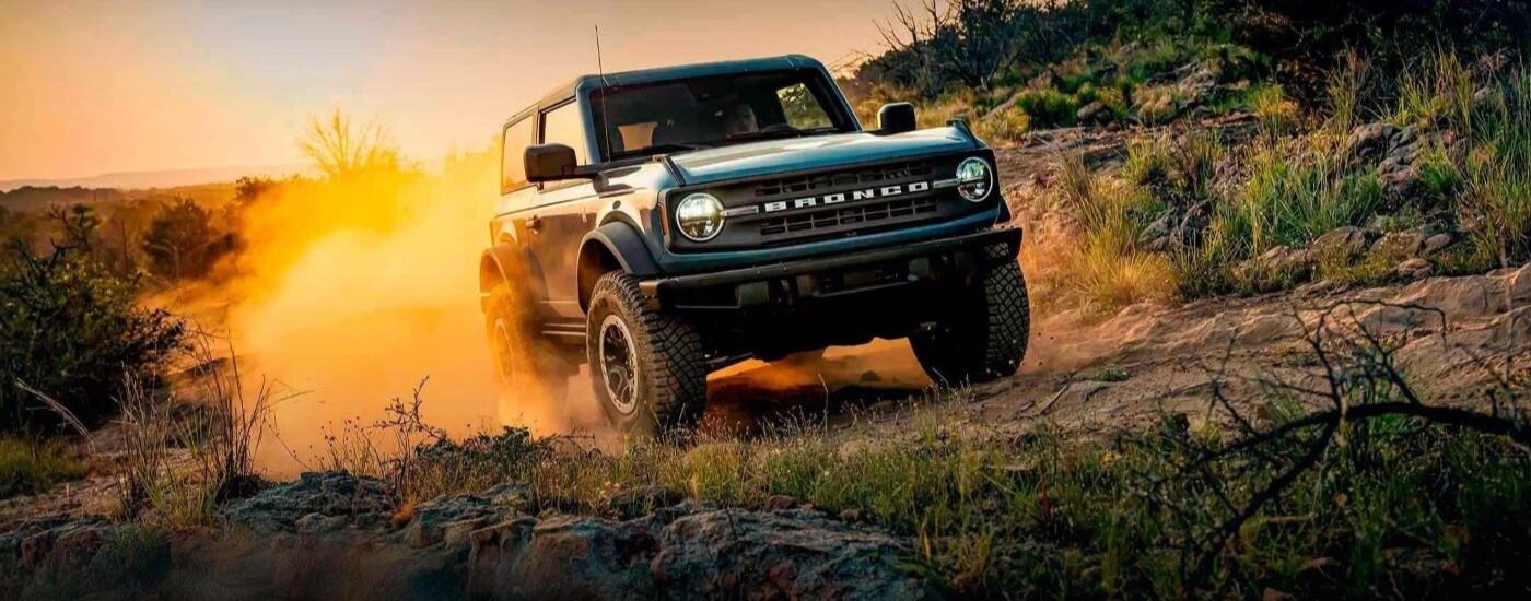 Blue 2022 Ford Bronco driving down a trail.