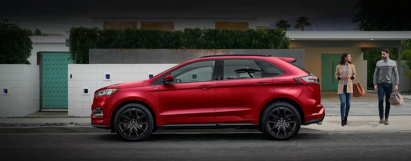 A red 2024 Ford Edge parked near a used car dealer near Huntingdon.