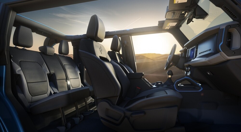 The black interior of a 2025 Ford Bronco for sale is shown from the side.