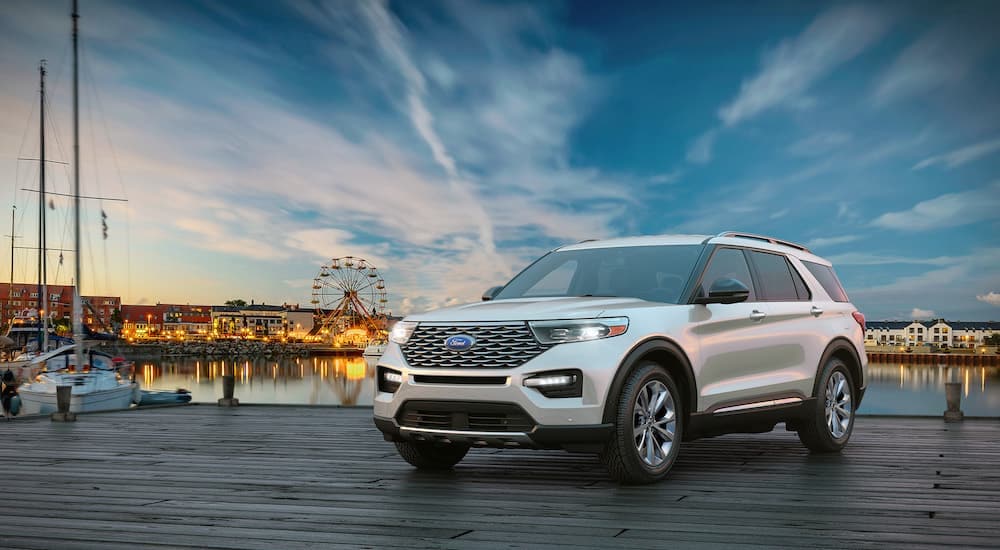 A white 2024 Ford Explorer is shown from the front at an angle on a pier.