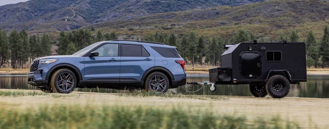 A blue Ford Explorer for sale in Milan is shown towing a trailer.