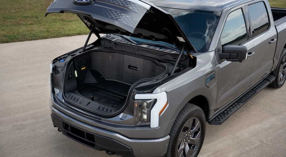 A close up of the open frunk in a grey 2024 Ford F-150 Lightning Flash.