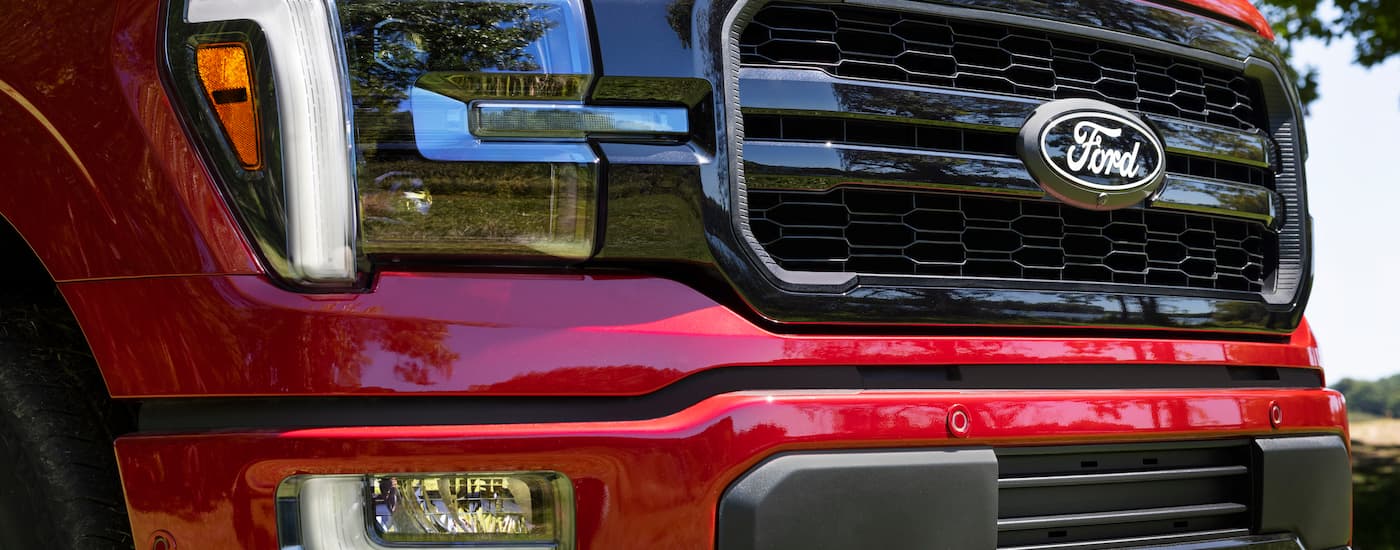 Headlight and grille on a red 2025 Ford F-150.