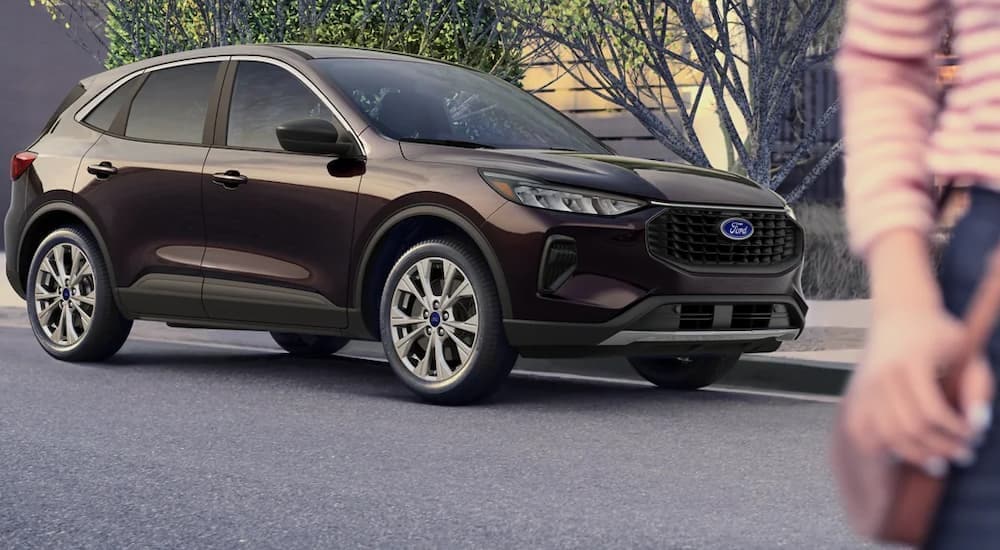 A maroon 2024 Ford Escape is shown from the front at an angle after leaving a Ford dealer near Medina.