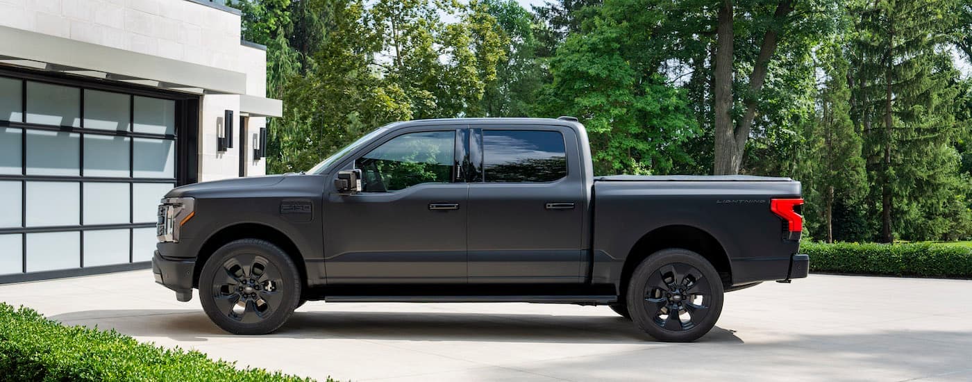 A black 2024 Ford F-150 Lightning Platinum is shown from the side.