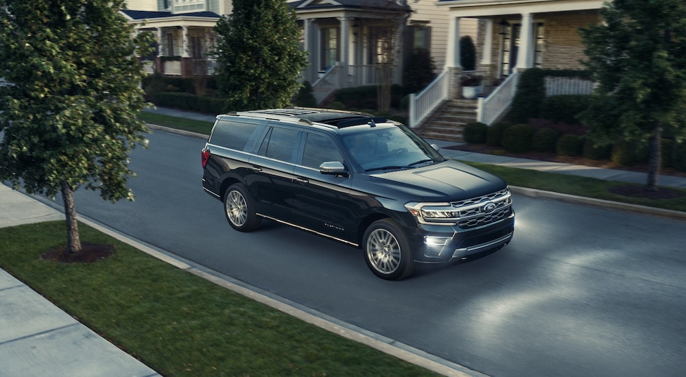 A black 2024 Ford Expedition driving through a neighborhood to a Ford dealer near Martin.