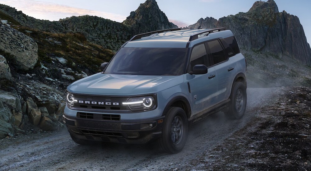 A grey 2024 Ford Bronco Sport Big Bend driving on a gravel mountain trail.