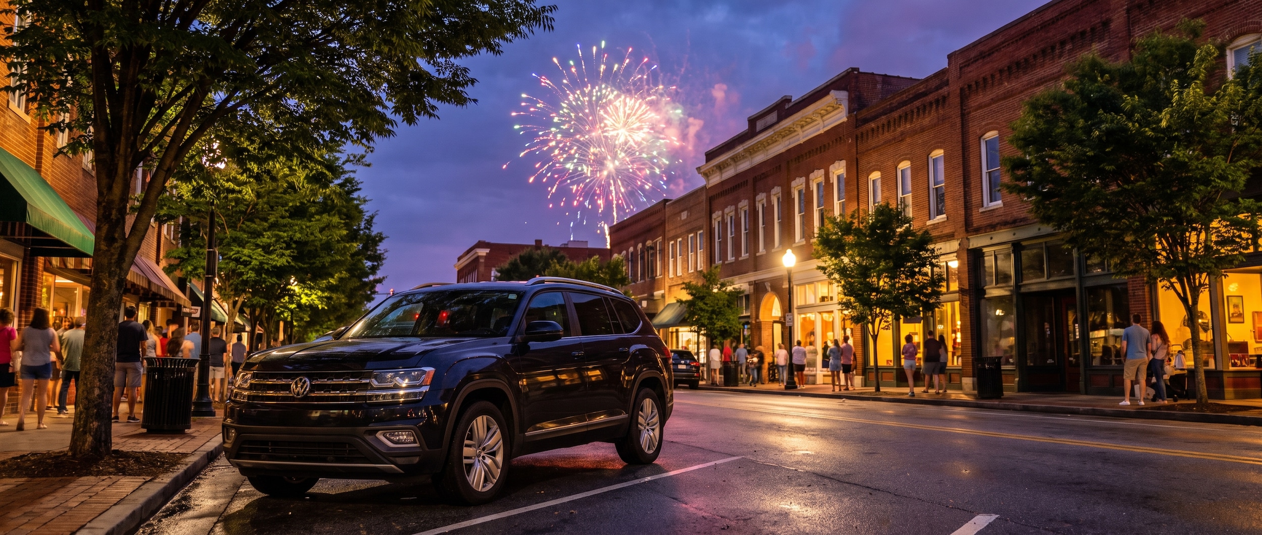 Volkswagen SUV parked in Greenville SC with fireworks bursting in the night sky reflected off a clean windshield