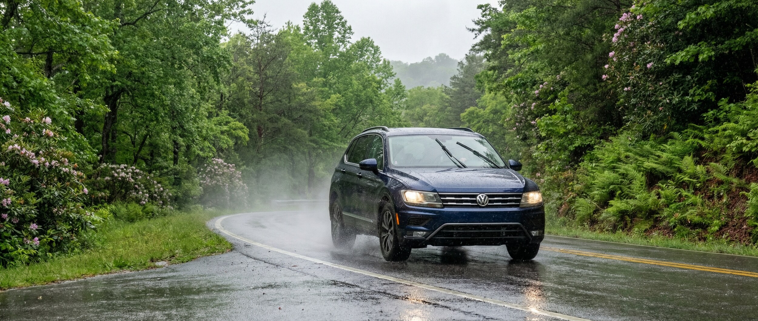 Volkswagen Tiguan driving safely on wet roads in Greenville SC during spring rain