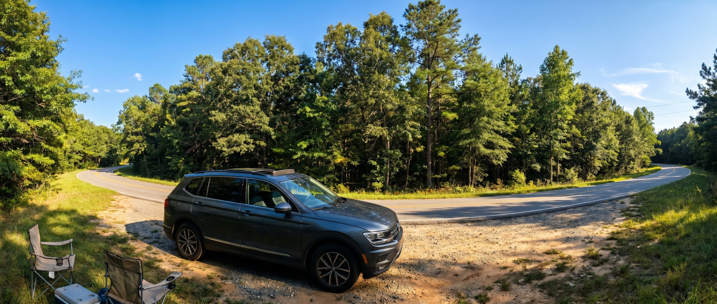 Volkswagen Tiguan sunroof open on a sunny summer day in Greenville, SC with green trees in background