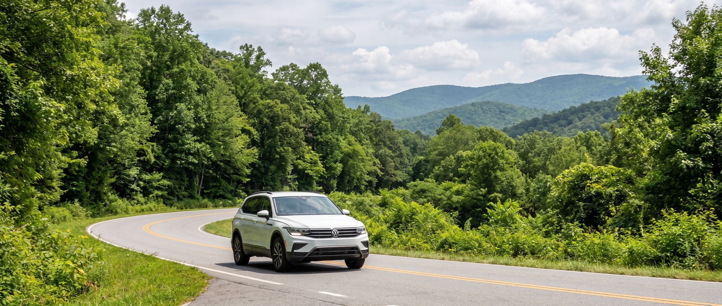 2026 Volkswagen Tiguan navigating a curvy mountain road on SC-11 toward Table Rock State Park in Upstate South Carolina