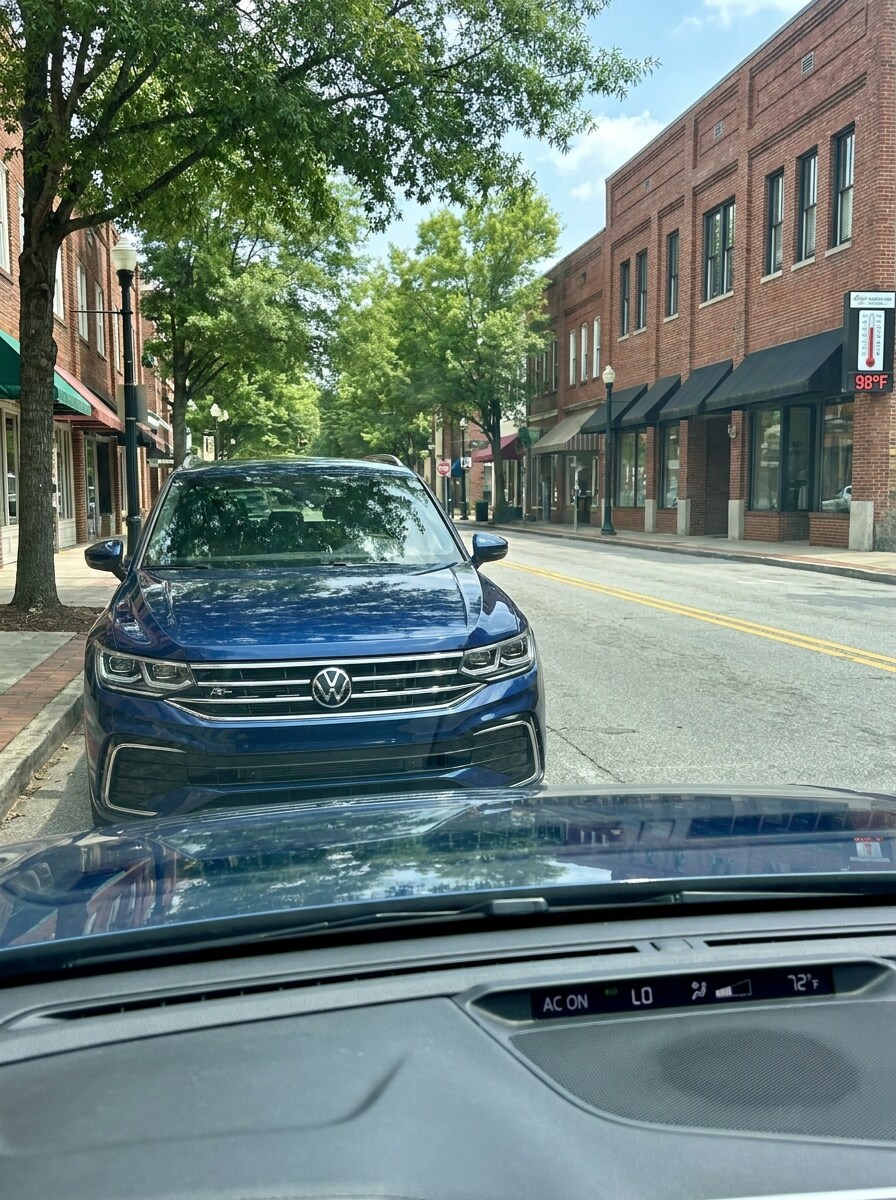 2026 Volkswagen Tiguan parked in Greenville SC summer heat with AC climate control visible through windshield