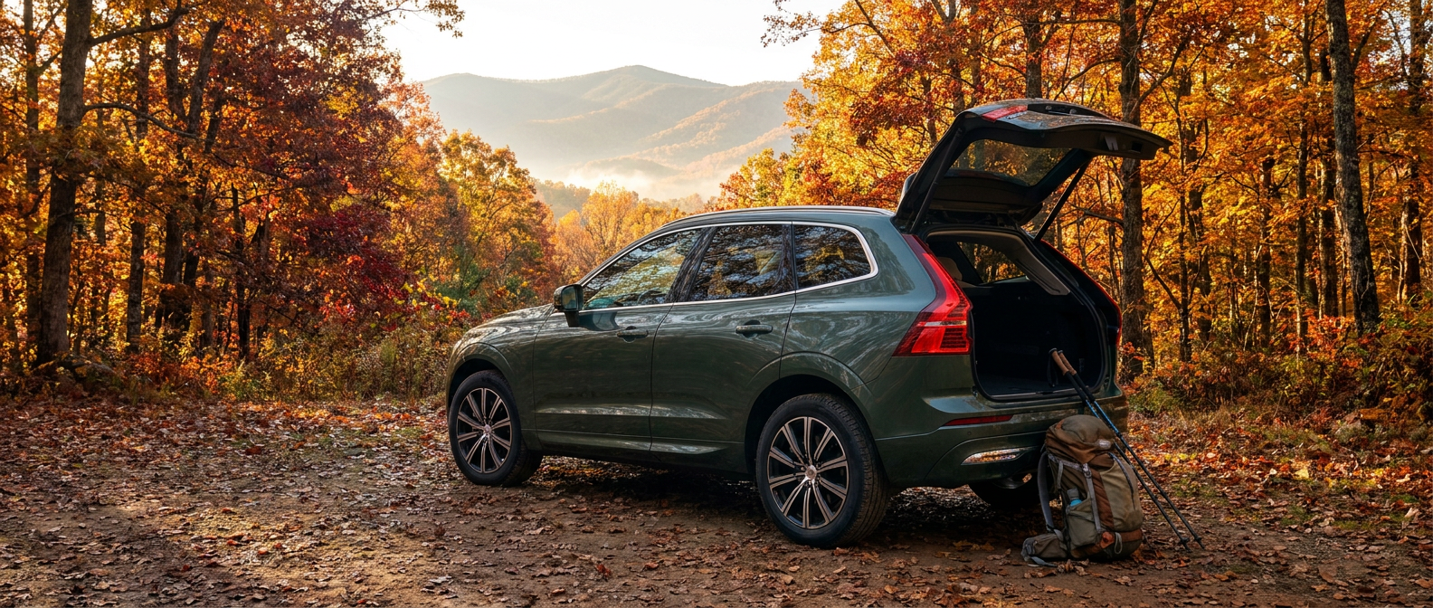 2026 Volvo XC60 at a fall hiking trailhead in Upstate South Carolina with rear hatch open and hiking gear loaded