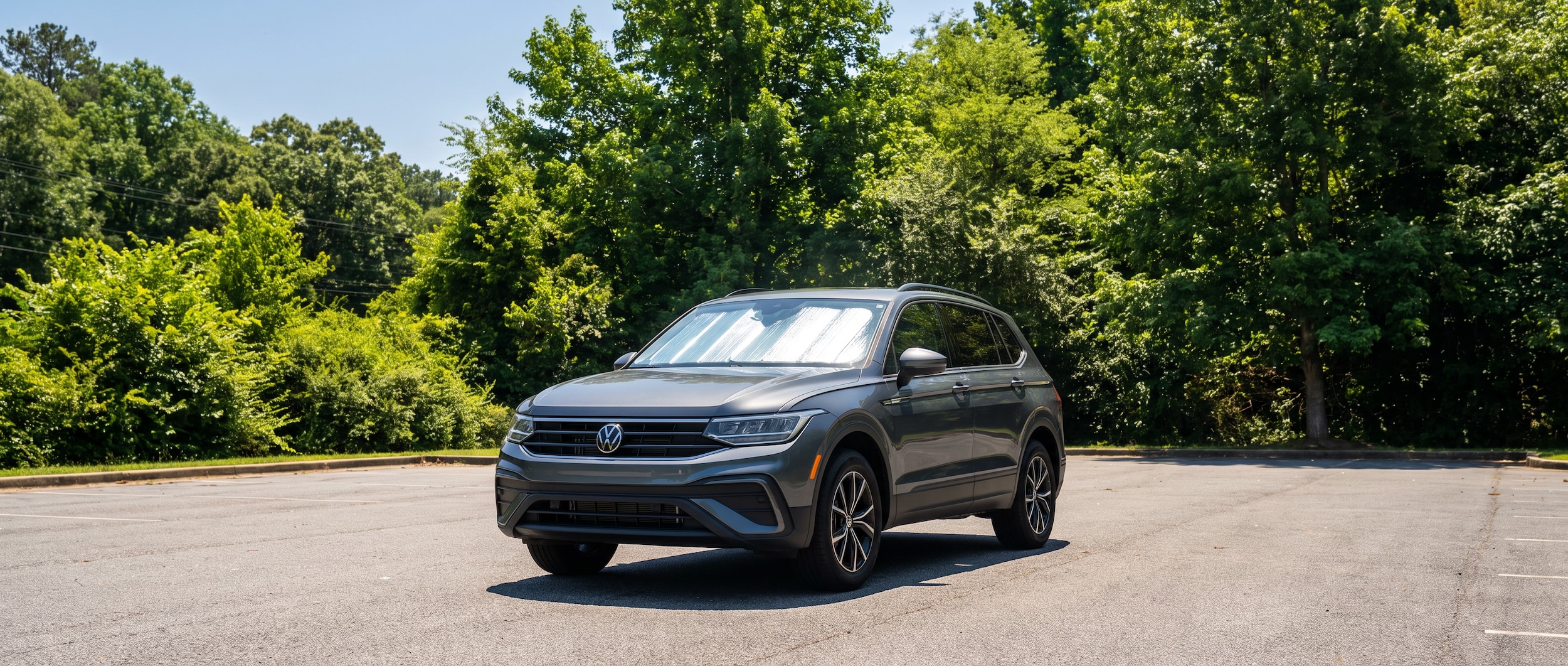 2026 Volkswagen Tiguan parked with a reflective windshield sunshade in a sunny Greenville, SC surface lot