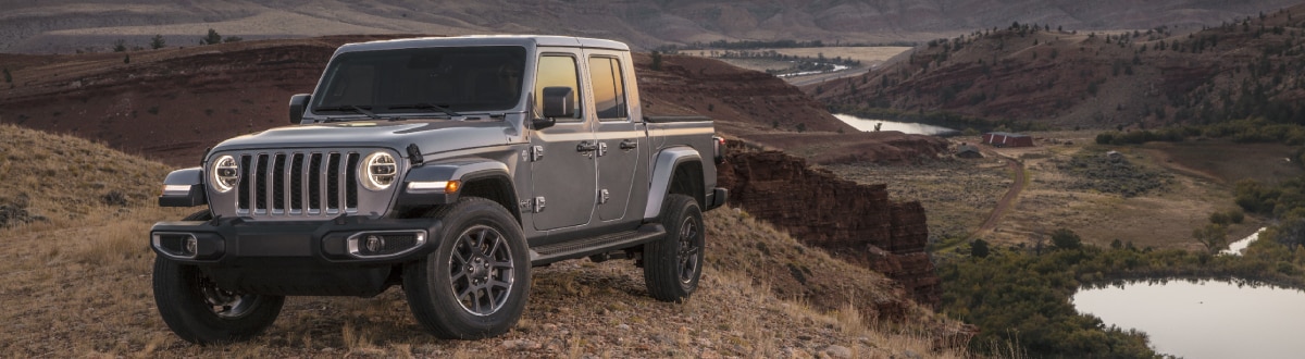 Jeep Gladiator on the top of a hill overlooking a lake