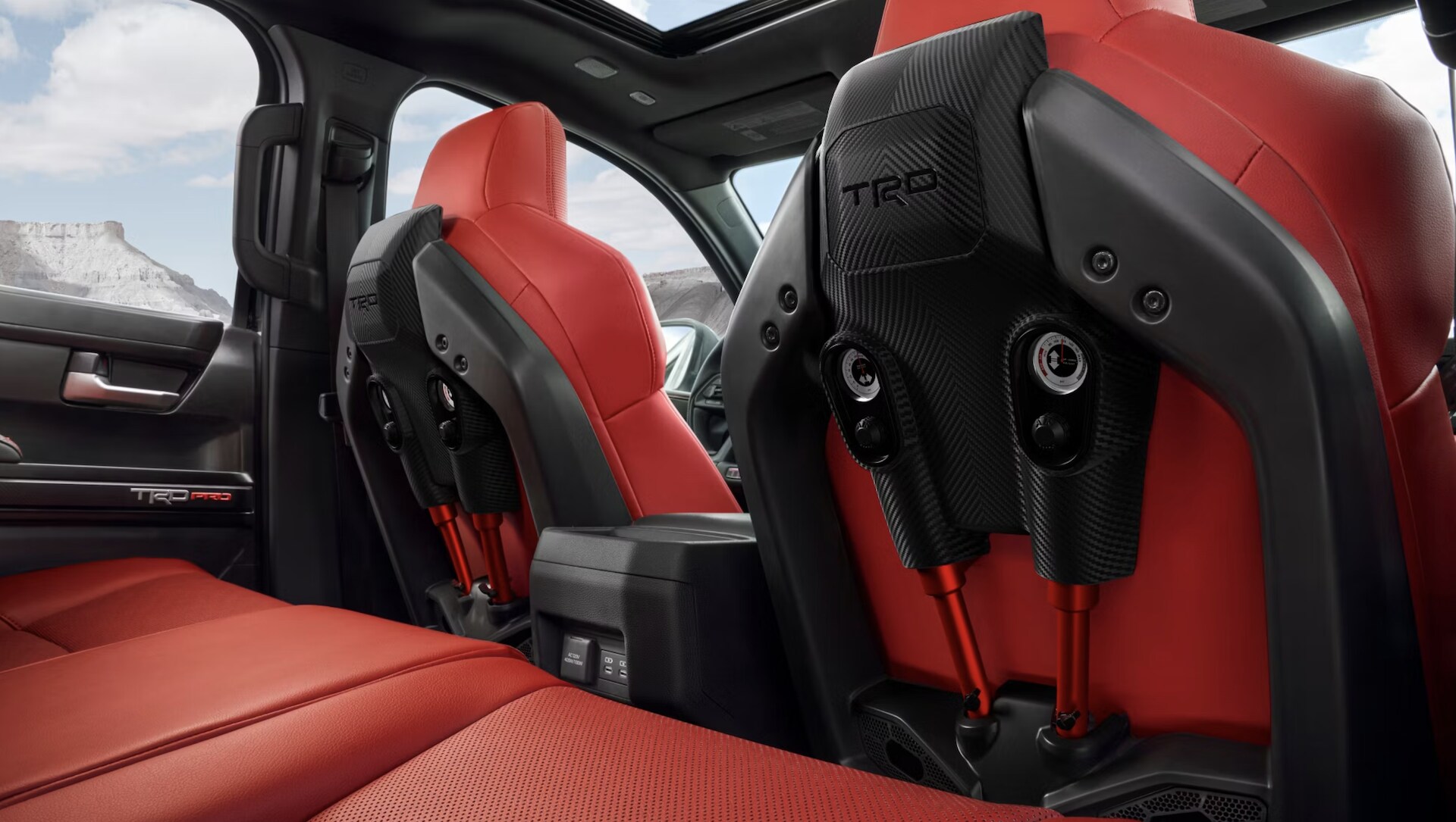 New%202025%20Toyota%20Tacoma%20Interior.png 2025 Toyota Tacoma Trailhunter with red and black interior for sale near Ennis, TX.