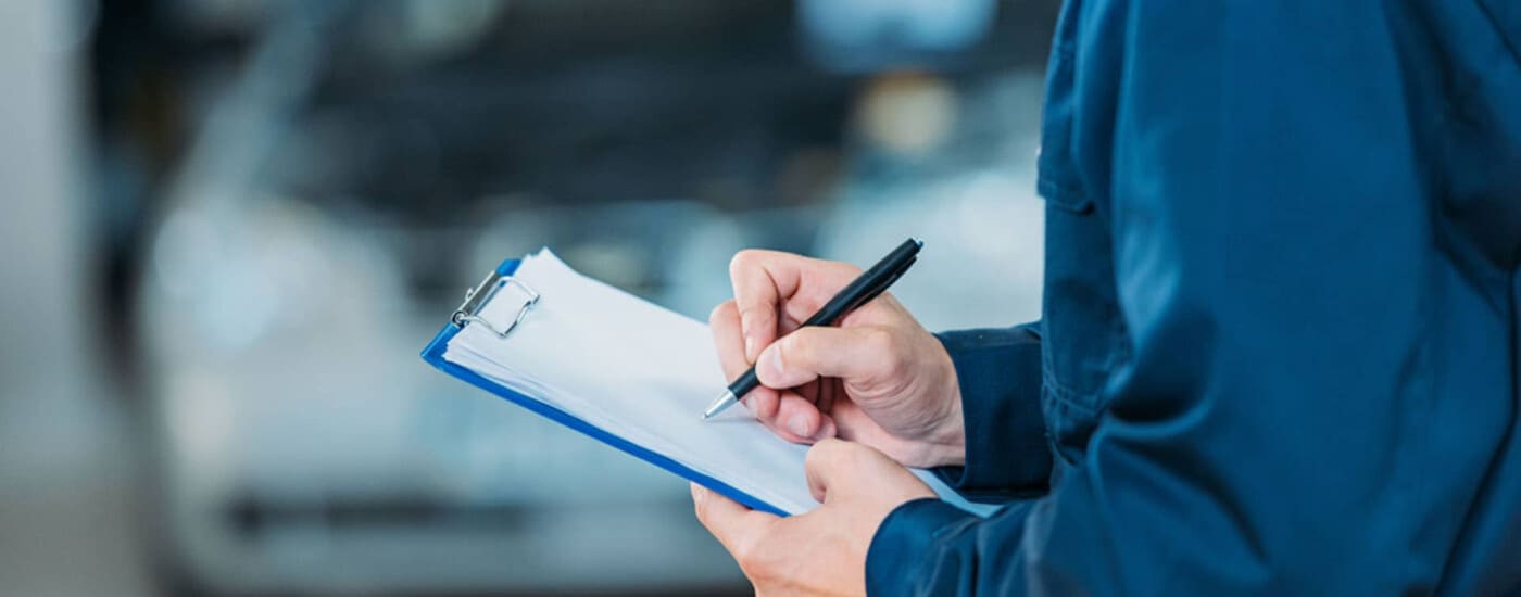Mechanic writing on clipboard