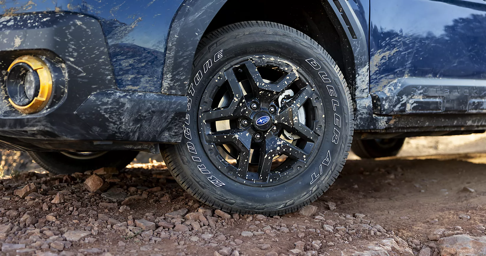 Subaru Outback wheel on rocky terrain