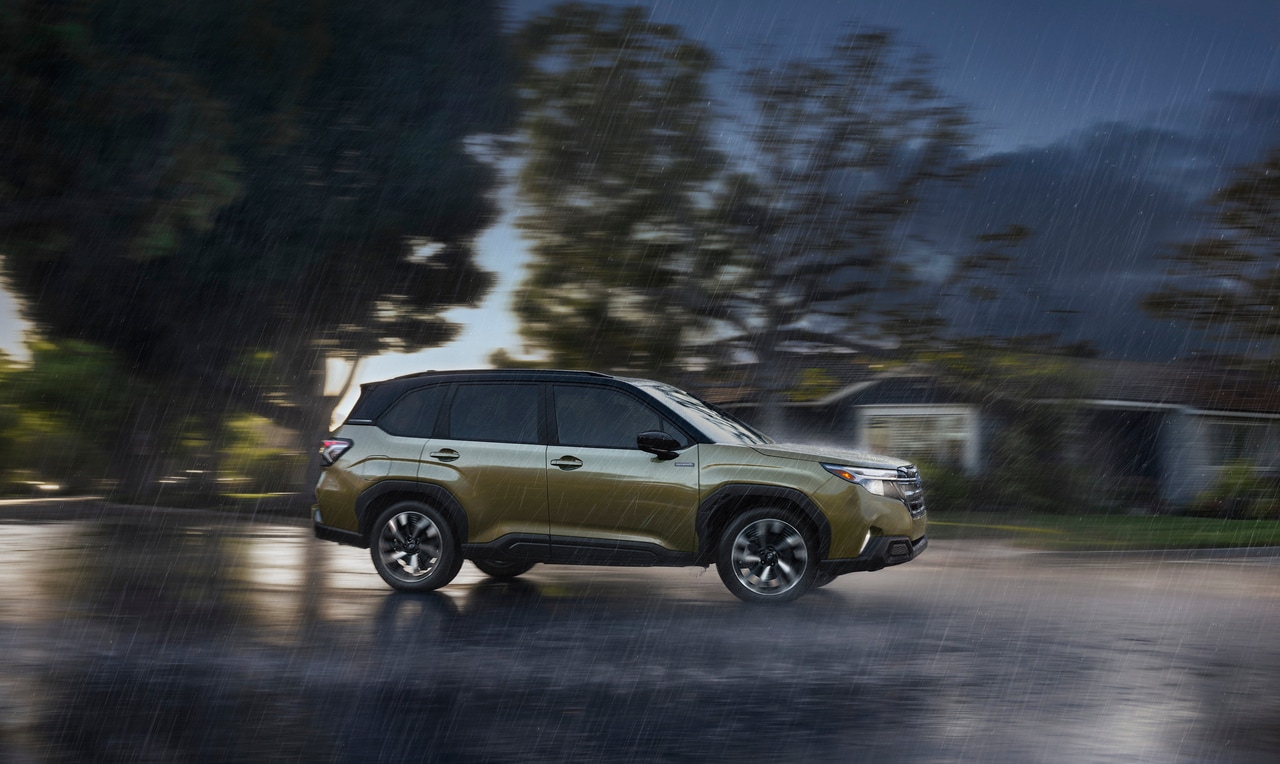  2025 Subaru Forester Hybrid on the road in the rain.