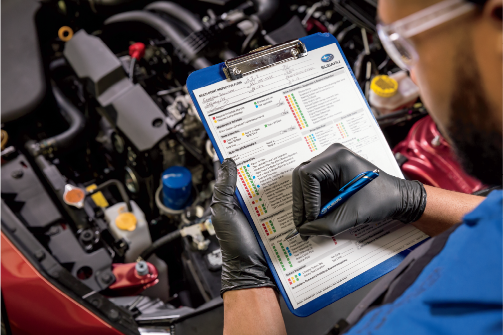 Subaru tech doing a multipoint inspection