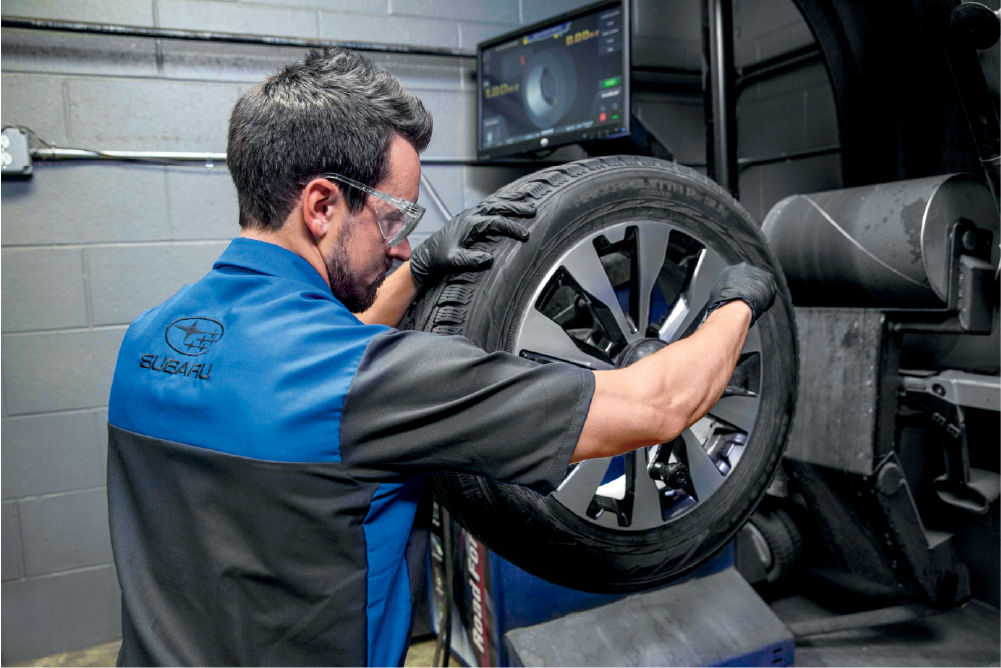 Subaru certified technician inspecting a tire