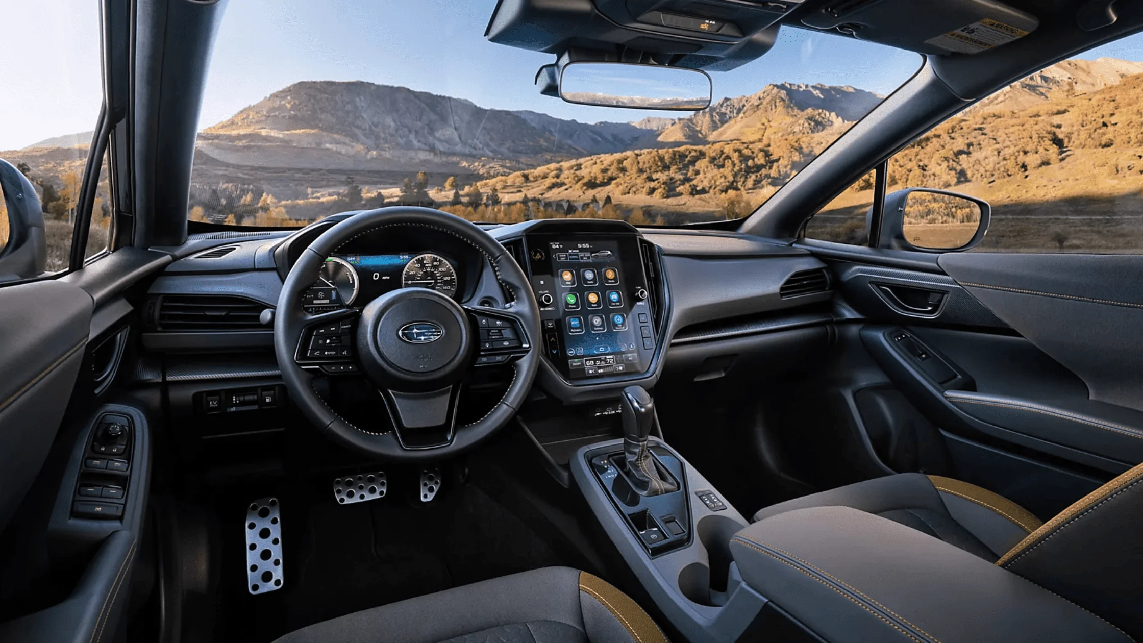 2026 Subaru Outback Wilderness all-black interior showing front and rear leather seats with touchscreen infotainment and mountain view through windows