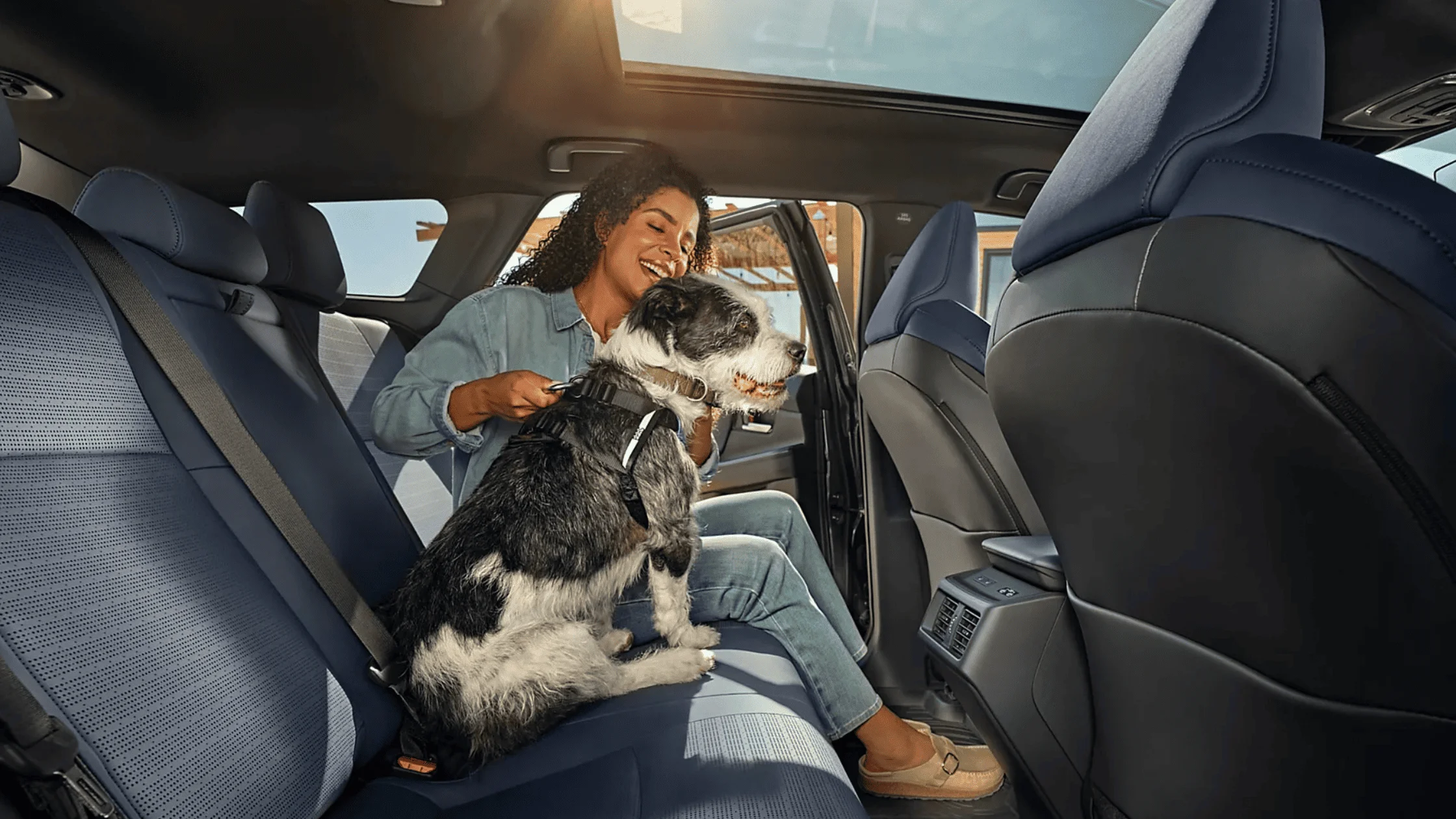 2026 Subaru Outback Wilderness cargo area loaded with camping gear including sleeping bag and trekking poles with rear hatch open in a desert setting