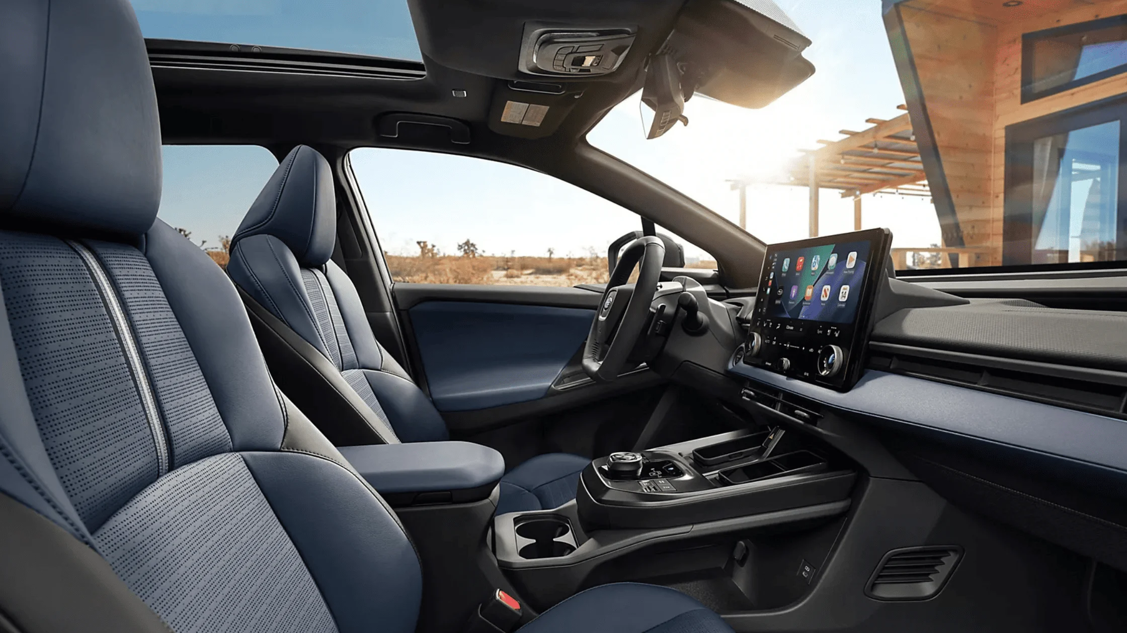 2026 Subaru Outback Wilderness all-black interior showing front and rear leather seats with touchscreen infotainment and mountain view through windows