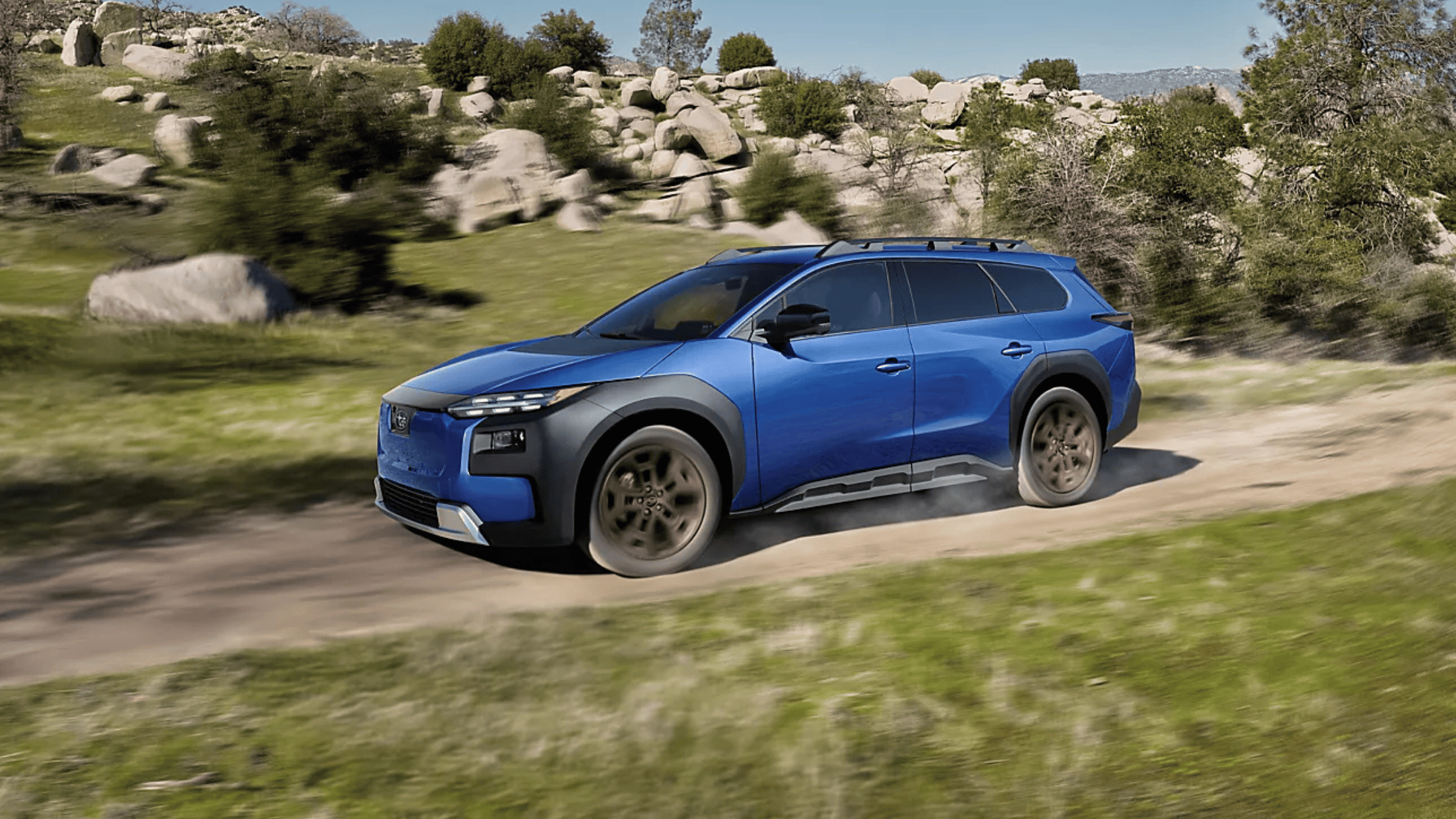 Blue 2026 Subaru Trailseeker electric SUV driving dirt trail near Pueblo CO
