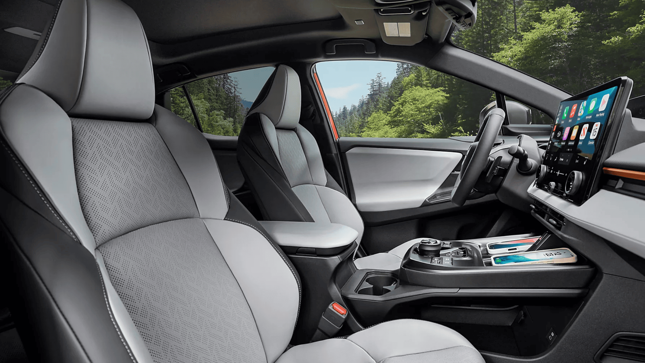 2026 Subaru Outback Wilderness cargo area loaded with camping gear including sleeping bag and trekking poles with rear hatch open in a desert setting