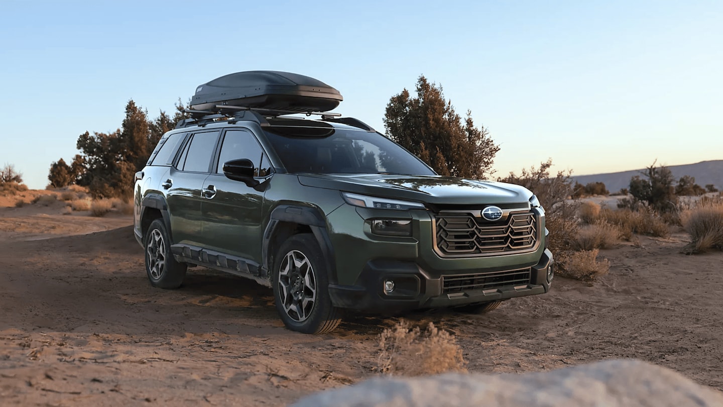 2026 Subaru Outback Wilderness in blue navigating a rocky off-road trail with roof rack in a desert canyon landscape, available in Pueblo CO