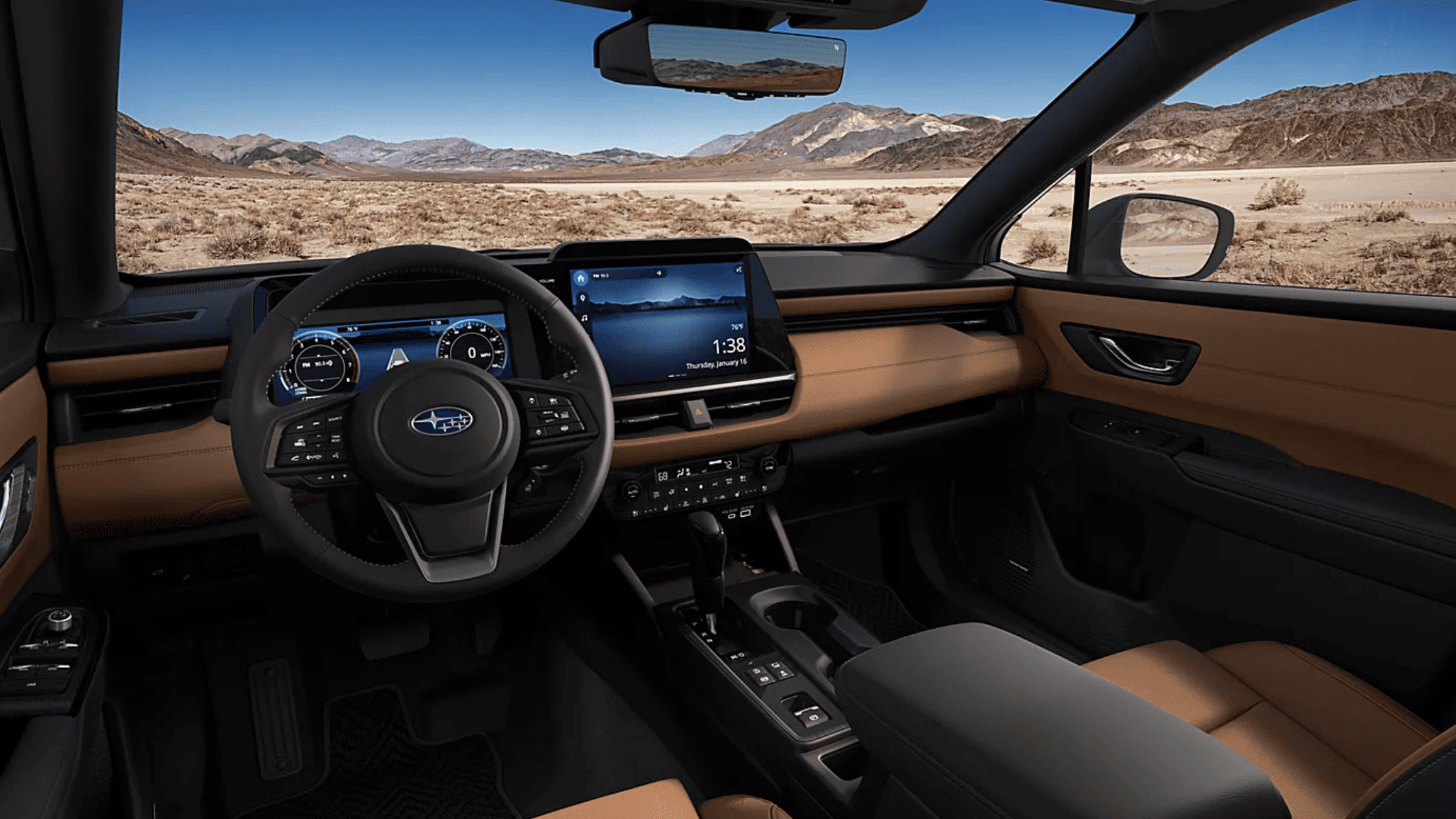 2026 Subaru Outback Wilderness cargo area loaded with camping gear including sleeping bag and trekking poles with rear hatch open in a desert setting