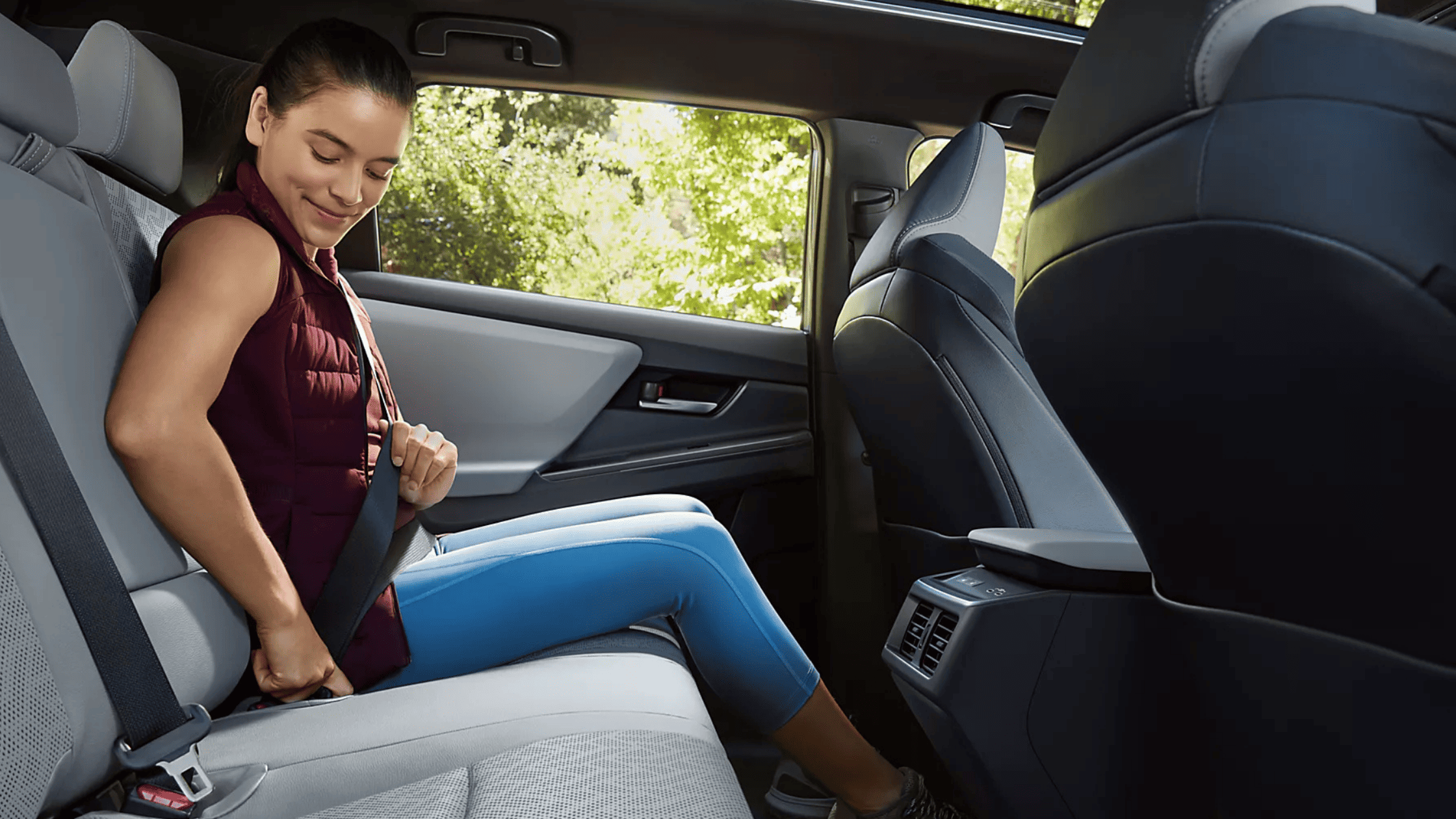 2026 Subaru Outback Wilderness cargo area loaded with camping gear including sleeping bag and trekking poles with rear hatch open in a desert setting