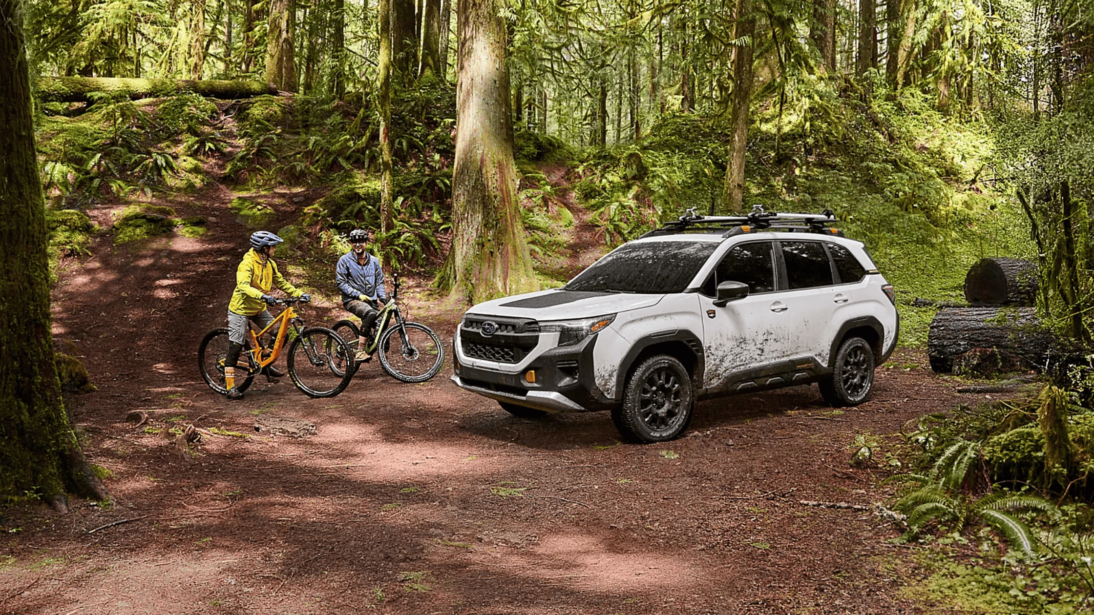 2026 Subaru Outback Wilderness in blue navigating a rocky off-road trail with roof rack in a desert canyon landscape, available in Pueblo CO