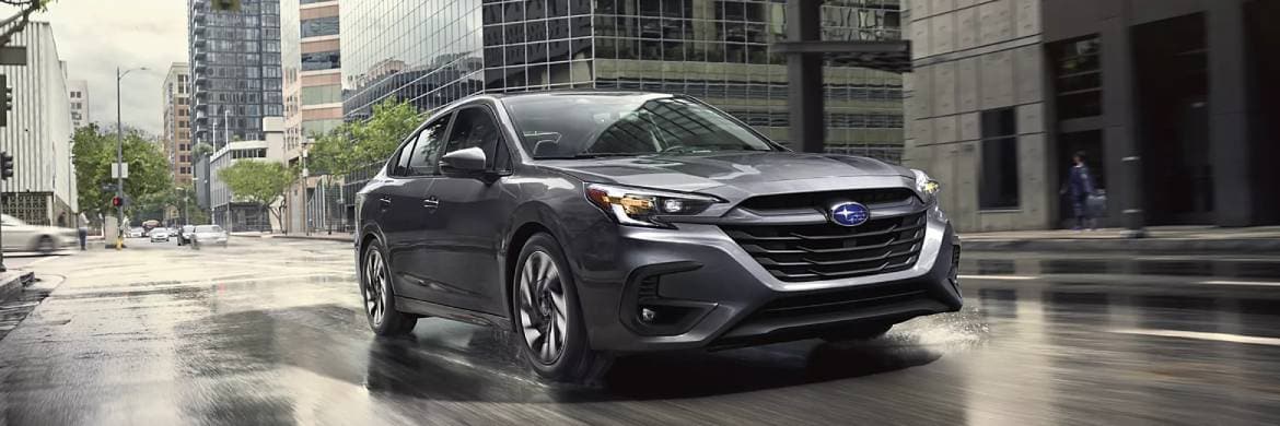 Redesigned 2025 Subaru vehicle parked on gravel road with misty field in background