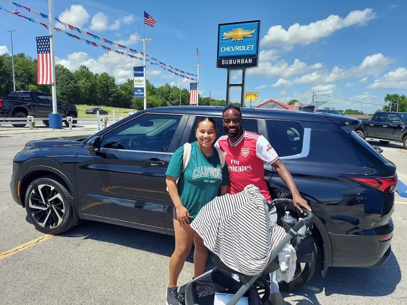 Happy family with vehicle bought from Suburban Chevrolet