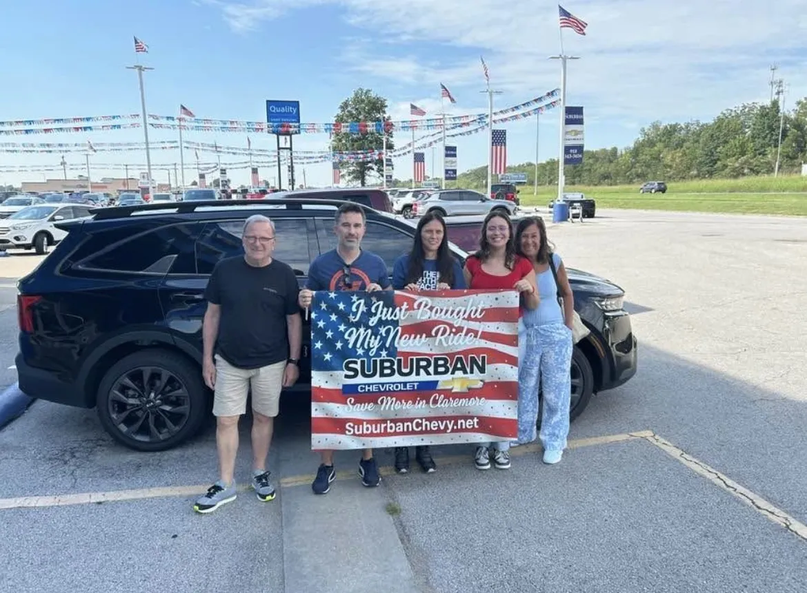 Family after purchasing a new Chevrolet at Suburban Chevrolet
