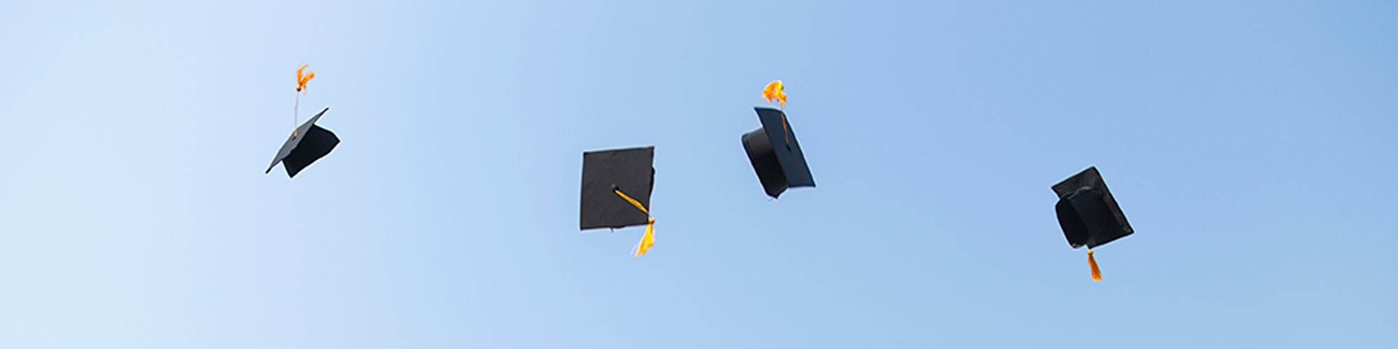 Graduation caps in the air