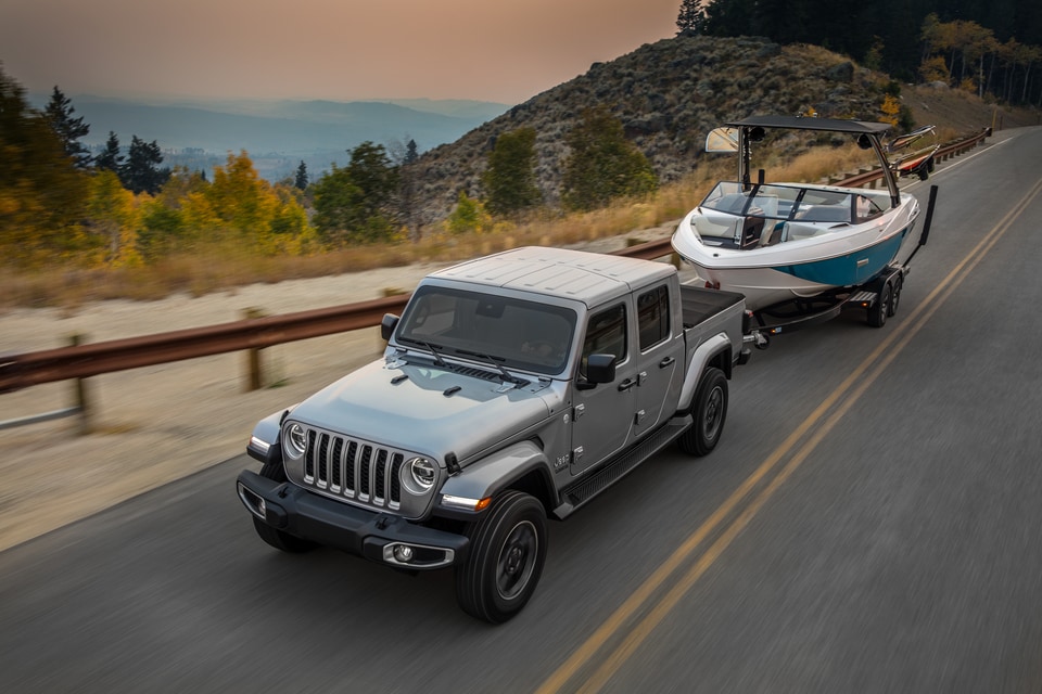 Jeep Gladiator Towing Boat on Desert Road