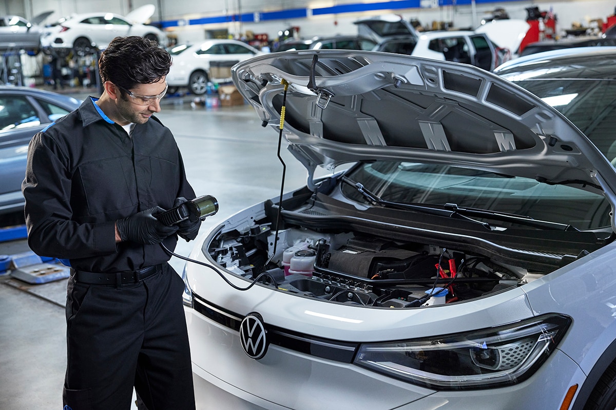 A Volkswagen service technician servicing an ID.4